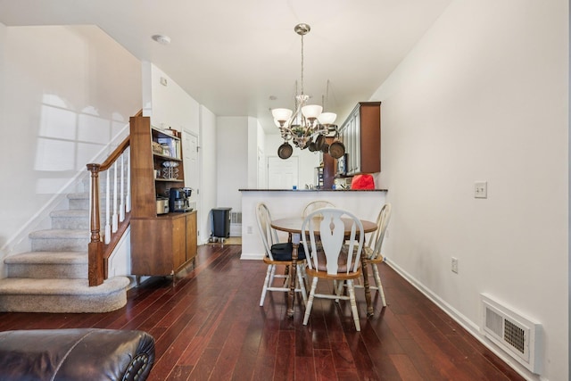 265 Custer Ave Unit 103, Jersey City, NJ 07305 - dining space with stairs, a chandelier, and dark wood-type flooring