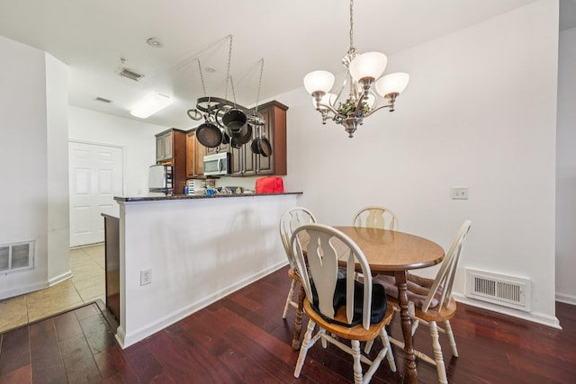 265 Custer Ave Unit 103, Jersey City, NJ 07305 - dining area featuring a chandelier and wood-type flooring