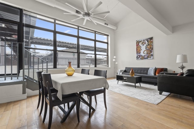 300 Communipaw Ave Unit 219, Jersey City, NJ 07304 - dining area with ceiling fan, wood finished floors, plenty of natural light, and lofted ceiling