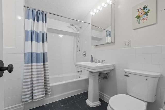 300 Communipaw Ave Unit 219, Jersey City, NJ 07304 - bathroom featuring tile walls, shower / bath combination with curtain, wainscoting, and a textured ceiling