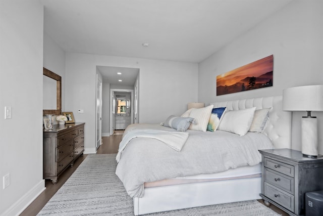 bedroom featuring dark wood finished floors and baseboards