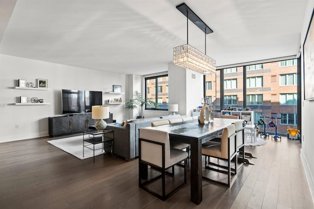 dining space featuring dark wood-style floors, baseboards, and a wall of windows