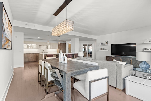 dining space featuring baseboards, recessed lighting, and light wood-style floors