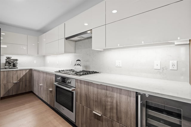 kitchen with white cabinets, appliances with stainless steel finishes, and light countertops