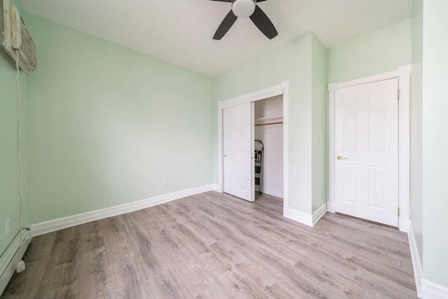 259 Griffith St Unit 1, Jersey City, NJ 07307 - unfurnished bedroom with a baseboard radiator, wood finished floors, a closet, and baseboards