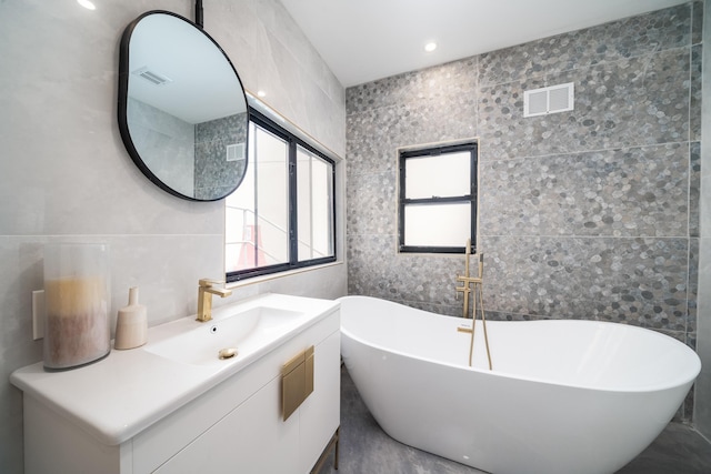 166 Steuben St Unit 1A, Jersey City, NJ 07302 - bathroom with tile walls, a freestanding tub, and vanity