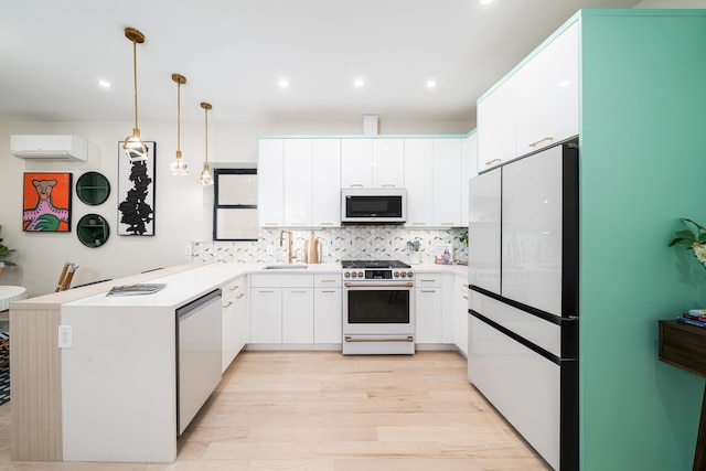 166 Steuben St Unit 1A, Jersey City, NJ 07302 - kitchen featuring white appliances, an AC wall unit, a sink, a peninsula, and light wood-style flooring