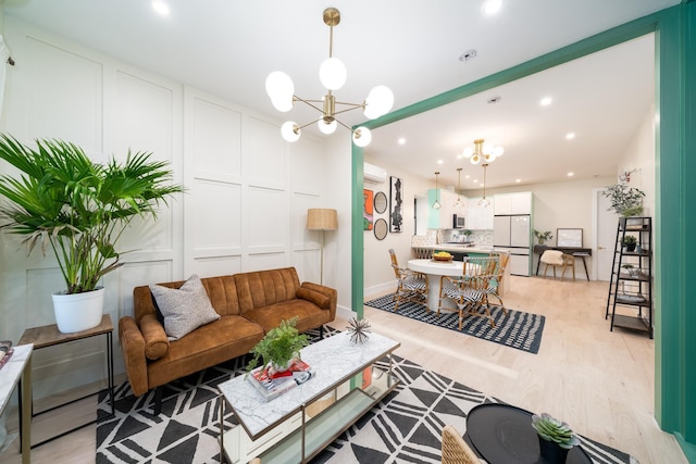 166 Steuben St Unit 1A, Jersey City, NJ 07302 - living room featuring a chandelier, light wood-style flooring, recessed lighting, and a decorative wall