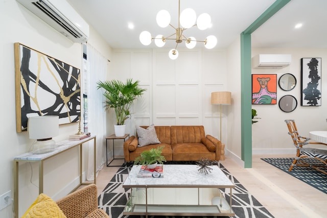 166 Steuben St Unit 1A, Jersey City, NJ 07302 - living area with a wall unit AC, light wood-type flooring, a chandelier, baseboards, and a decorative wall