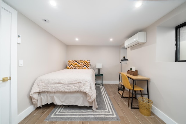 166 Steuben St Unit 1A, Jersey City, NJ 07302 - bedroom featuring an AC wall unit, wood finished floors, baseboards, and recessed lighting