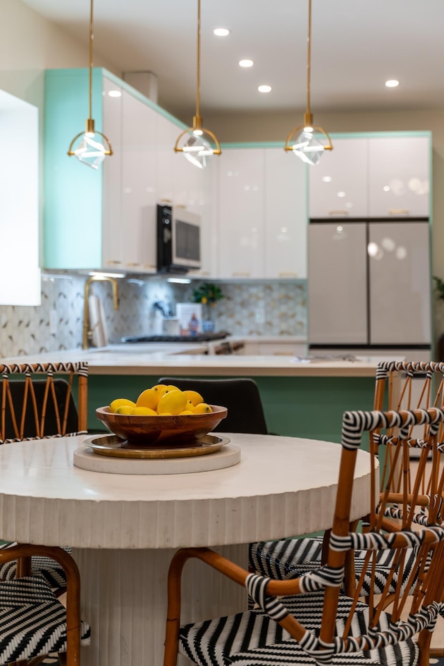 166 Steuben St Unit 1A, Jersey City, NJ 07302 - kitchen featuring white microwave, white cabinets, modern cabinets, pendant lighting, and recessed lighting