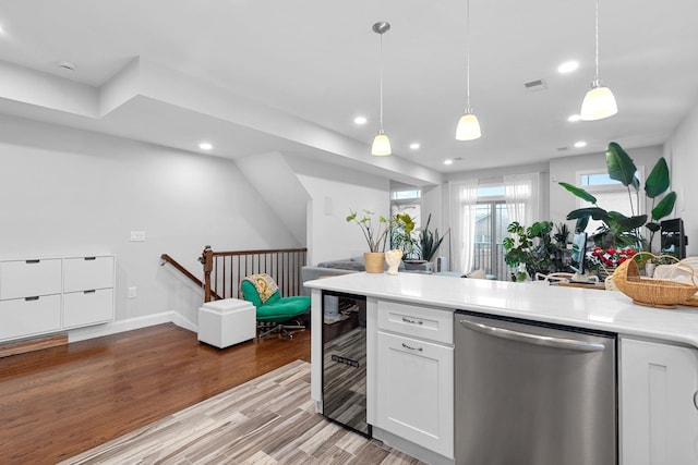 42 Grace St Unit 2A, Jersey City, NJ 07307 - kitchen featuring stainless steel dishwasher, recessed lighting, light countertops, white cabinetry, and light wood-style floors