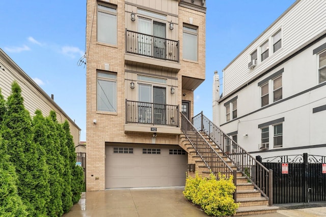 42 Grace St Unit 2A, Jersey City, NJ 07307 - view of front facade with brick siding, an attached garage, stairway, and driveway