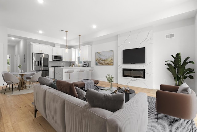 119 Van Horne St Unit 2, Jersey City, NJ 07304 - living area featuring light wood-style floors, recessed lighting, and a high end fireplace