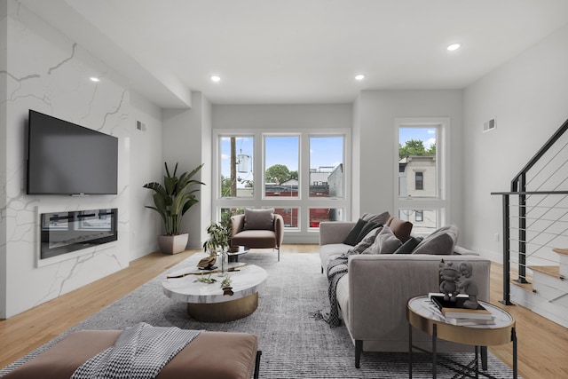 119 Van Horne St Unit 2, Jersey City, NJ 07304 - living room with stairs, wood finished floors, a high end fireplace, and recessed lighting