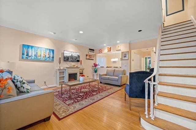 living room with hardwood / wood-style floors and ornamental molding