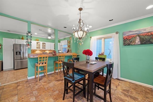 dining space featuring crown molding and ceiling fan with notable chandelier