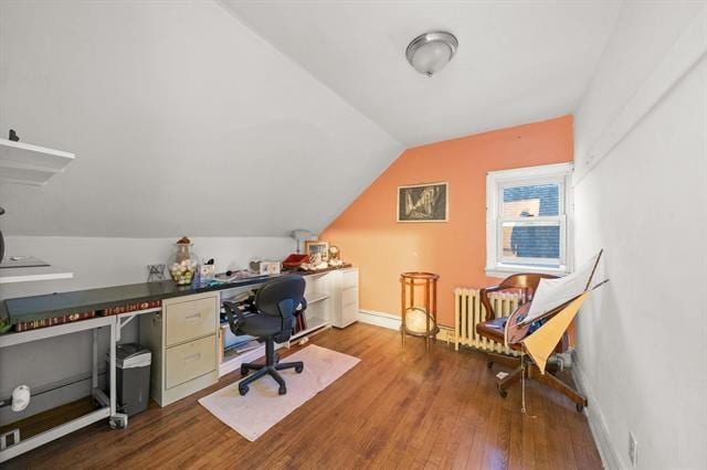 office space with wood-type flooring and vaulted ceiling