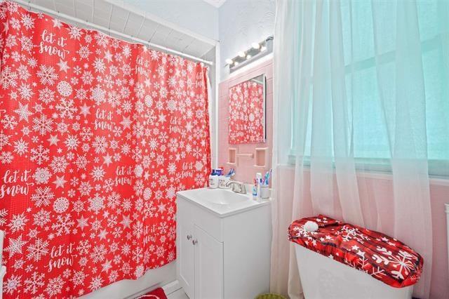 full bathroom with shower / tub combo with curtain, vanity, and toilet