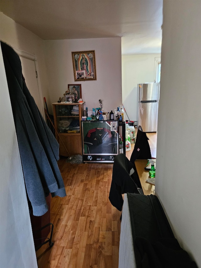 hallway with hardwood / wood-style flooring