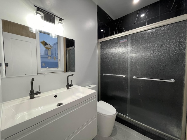 bathroom with vanity, toilet, and a shower stall