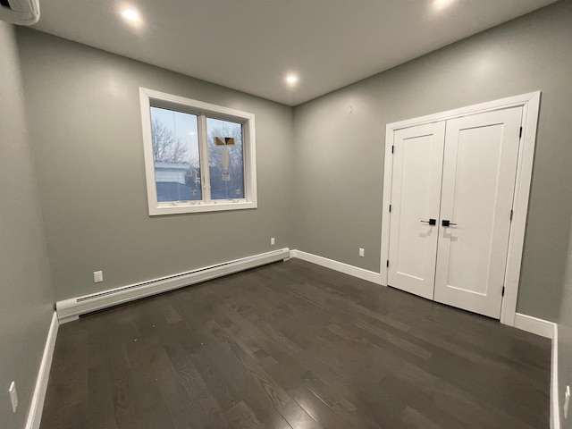 unfurnished bedroom featuring recessed lighting, baseboards, dark wood-style flooring, and a baseboard radiator