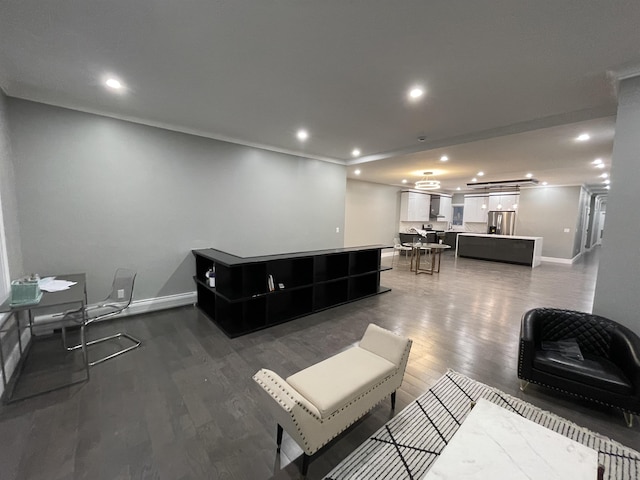 living area featuring dark wood finished floors, recessed lighting, baseboards, and ornamental molding