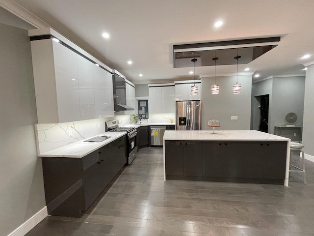 kitchen featuring a spacious island, stainless steel appliances, white cabinets, decorative light fixtures, and modern cabinets