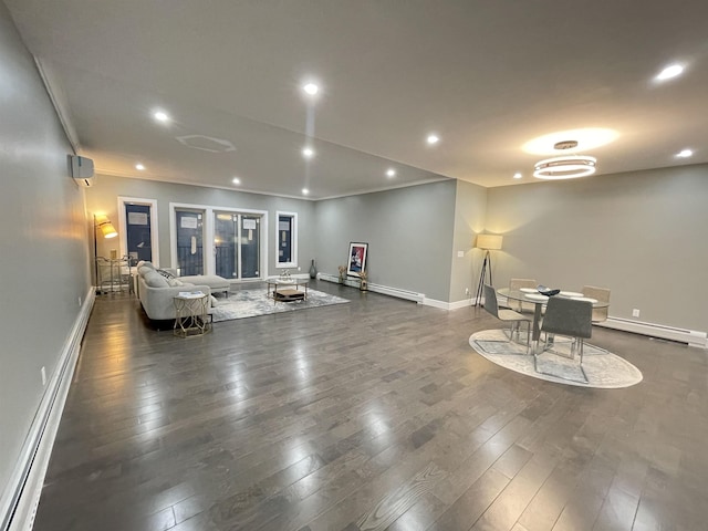 living room with a baseboard heating unit, recessed lighting, and wood-type flooring