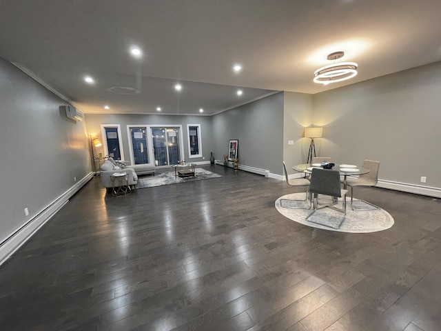 interior space with wood finished floors, baseboards, a baseboard radiator, recessed lighting, and crown molding