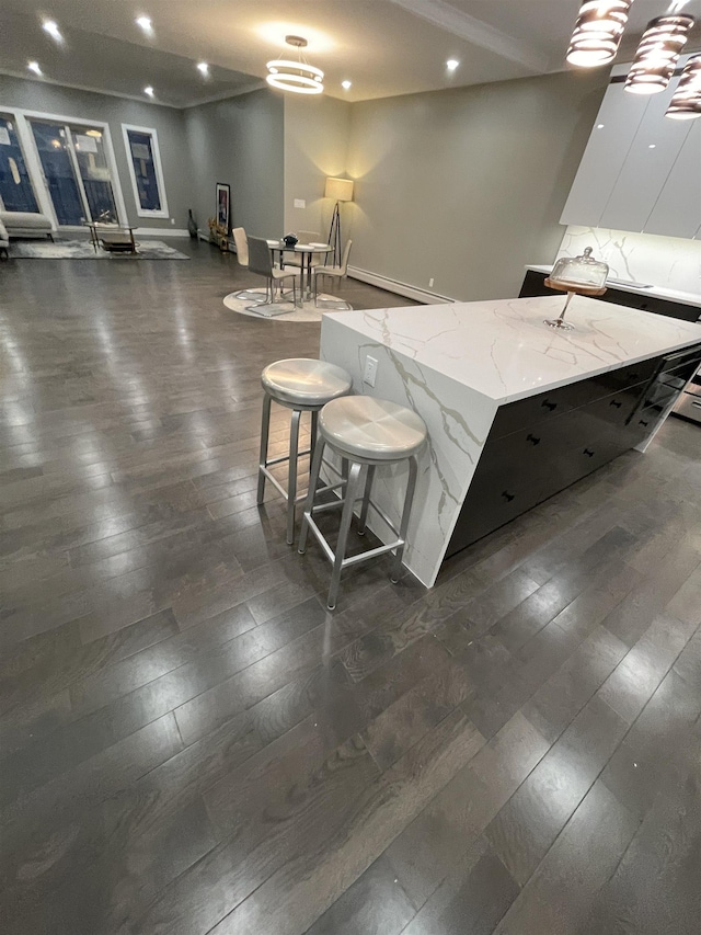 kitchen with light stone countertops, dark wood-style flooring, recessed lighting, white cabinetry, and modern cabinets