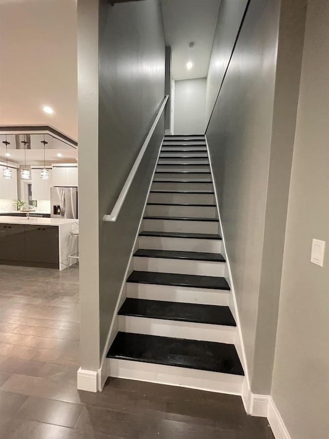 stairs featuring recessed lighting, baseboards, and wood finished floors