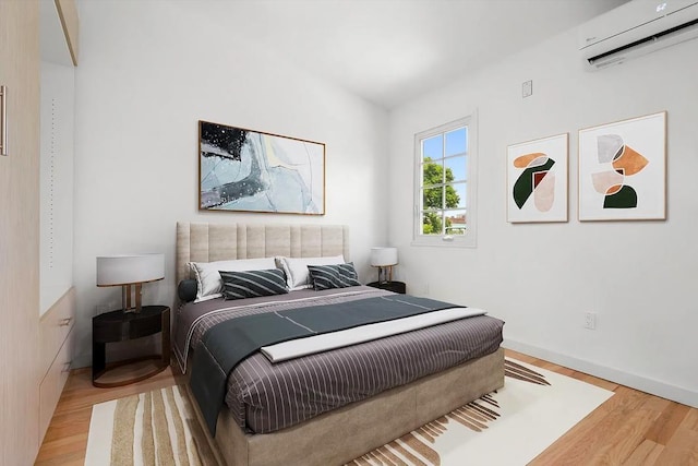 618 17th St, Union City, NJ 07087 - bedroom with a wall mounted air conditioner and light wood-type flooring