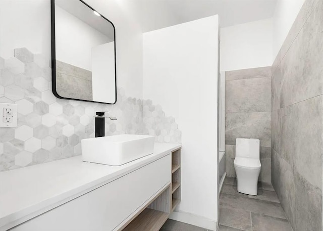 618 17th St, Union City, NJ 07087 - bathroom featuring vanity, tile walls, and decorative backsplash