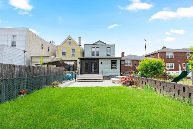 618 17th St, Union City, NJ 07087 - rear view of property featuring a patio area, a fenced backyard, and french doors