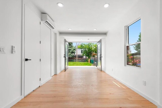 618 17th St, Union City, NJ 07087 - hall featuring a wall mounted air conditioner, recessed lighting, and light wood-type flooring