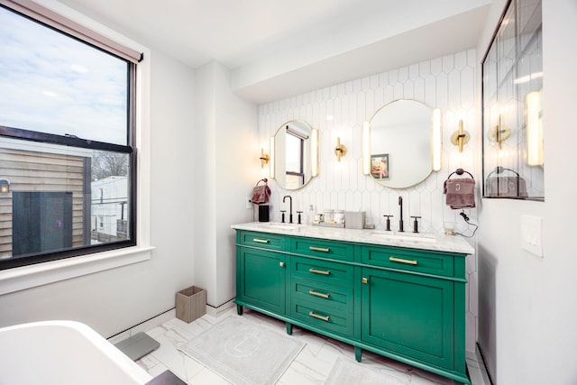 294 4th St, Jersey City, NJ 07302 - full bathroom with marble finish floor, a soaking tub, double vanity, and a sink