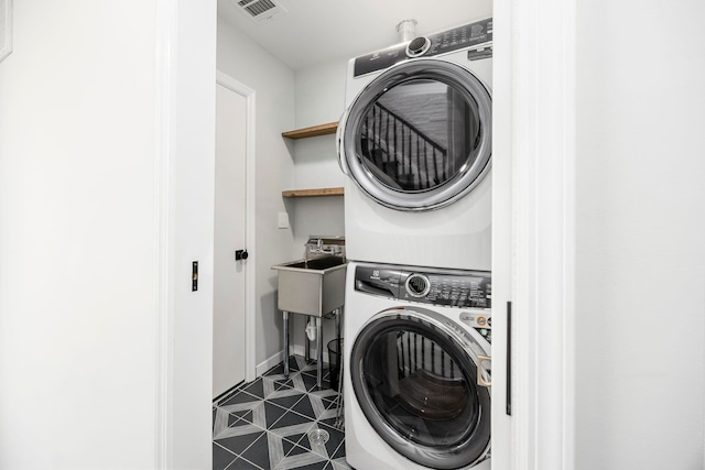 294 4th St, Jersey City, NJ 07302 - laundry room with visible vents, stacked washing maching and dryer, and laundry area