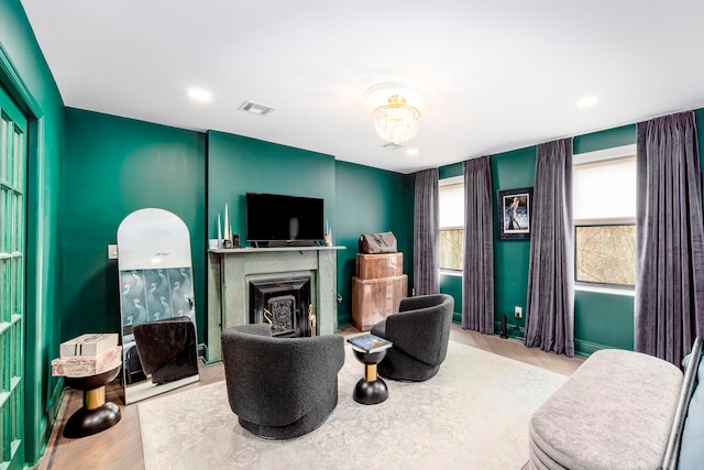 294 4th St, Jersey City, NJ 07302 - living room featuring recessed lighting, a fireplace, visible vents, and wood finished floors