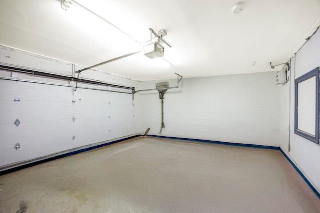 294 4th St, Jersey City, NJ 07302 - garage featuring an AC wall unit, baseboards, and a garage door opener
