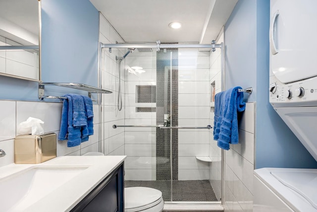 294 4th St, Jersey City, NJ 07302 - full bath with stacked washer / dryer, a stall shower, vanity, and toilet