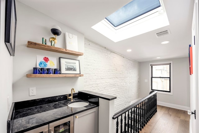 294 4th St, Jersey City, NJ 07302 - bathroom with visible vents, recessed lighting, wood finished floors, beverage cooler, and baseboards