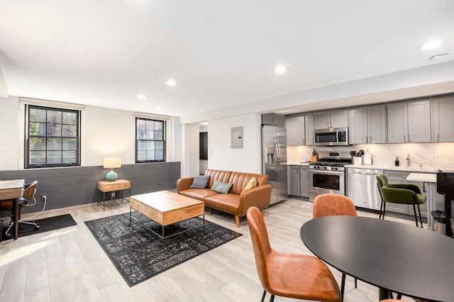 294 4th St, Jersey City, NJ 07302 - living room featuring light wood-type flooring, electric panel, plenty of natural light, and recessed lighting