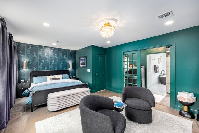 294 4th St, Jersey City, NJ 07302 - bedroom with visible vents, baseboards, an accent wall, a chandelier, and wallpapered walls