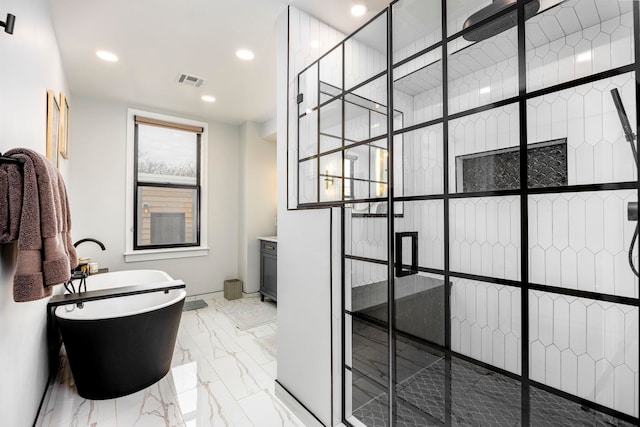 294 4th St, Jersey City, NJ 07302 - bathroom with visible vents, a freestanding tub, recessed lighting, marble finish floor, and a stall shower