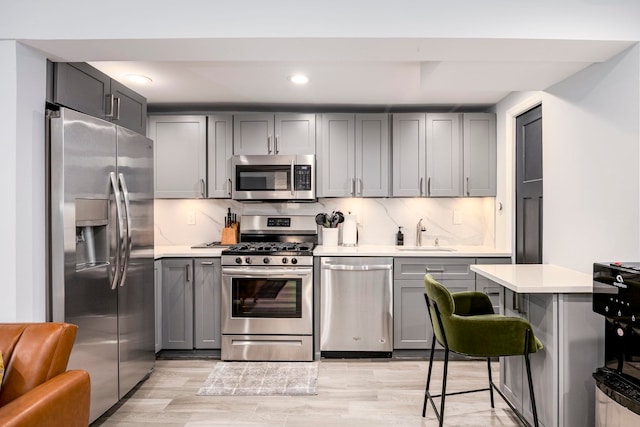 294 4th St, Jersey City, NJ 07302 - kitchen with a sink, light countertops, gray cabinetry, and stainless steel appliances