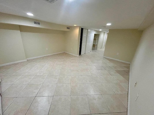 basement with light tile patterned flooring