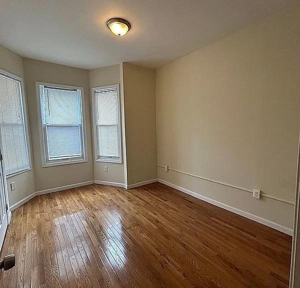 empty room with wood-type flooring