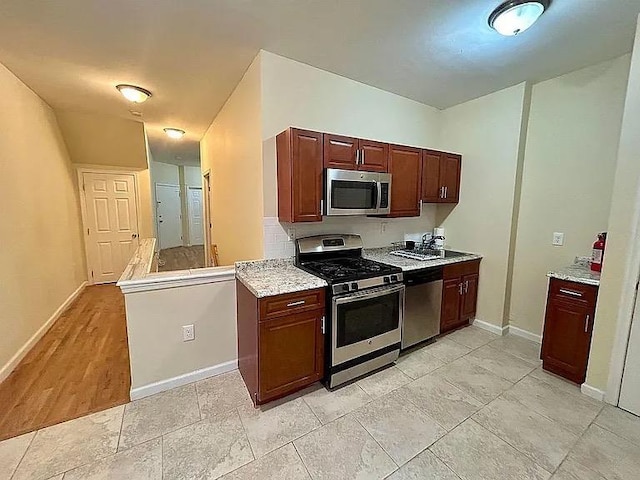 kitchen featuring kitchen peninsula and stainless steel appliances