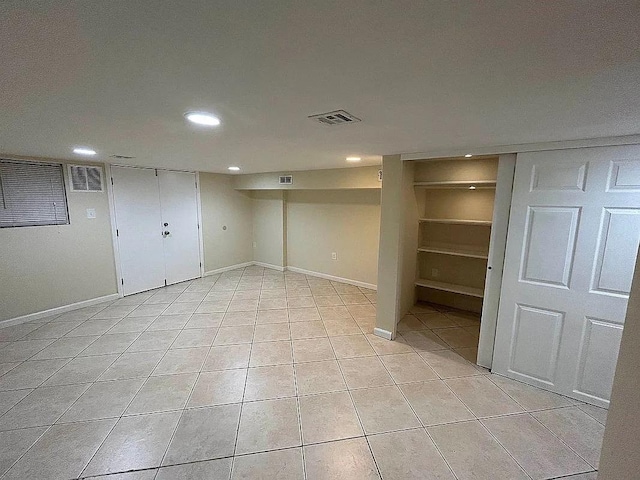 basement with light tile patterned flooring